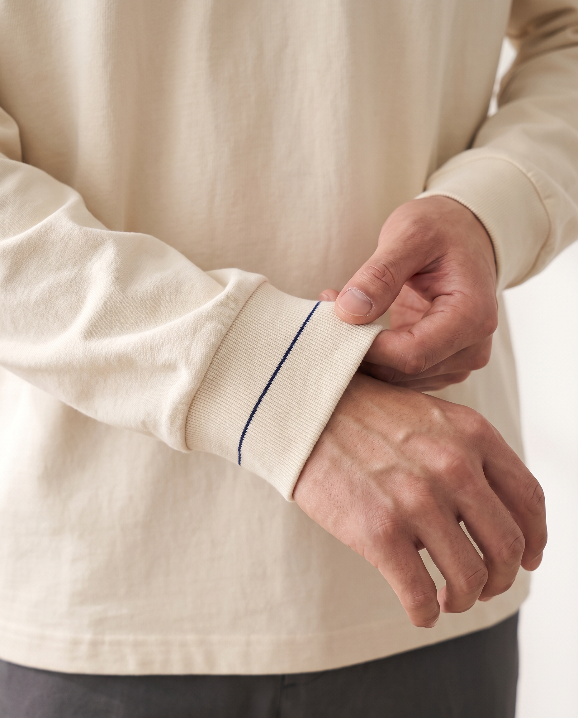 The Heavy Long Sleeve, navy signature stitch on the ribbed cuff, milk apricot