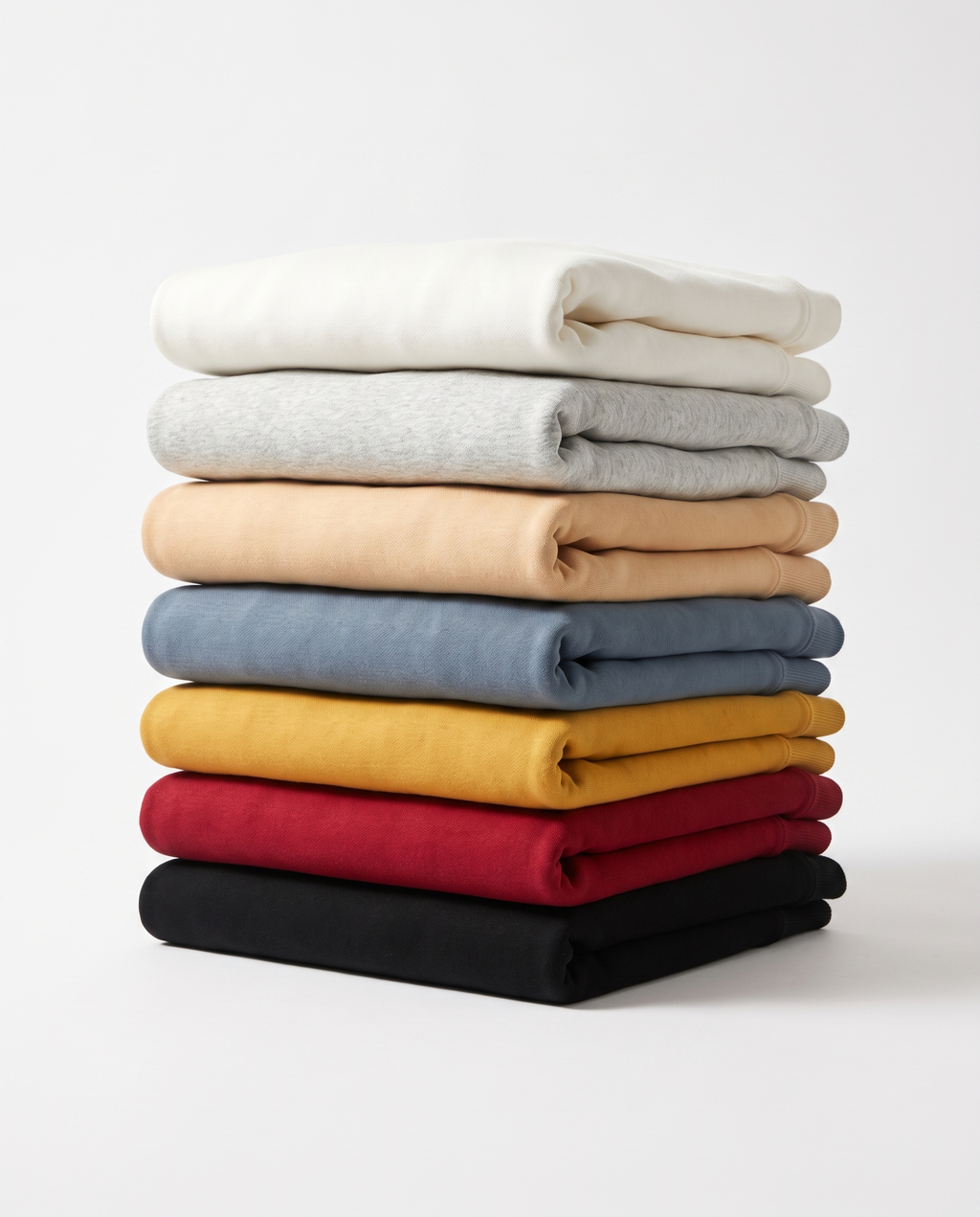 The Heavy Hoodie, all seven colours folded in a stack