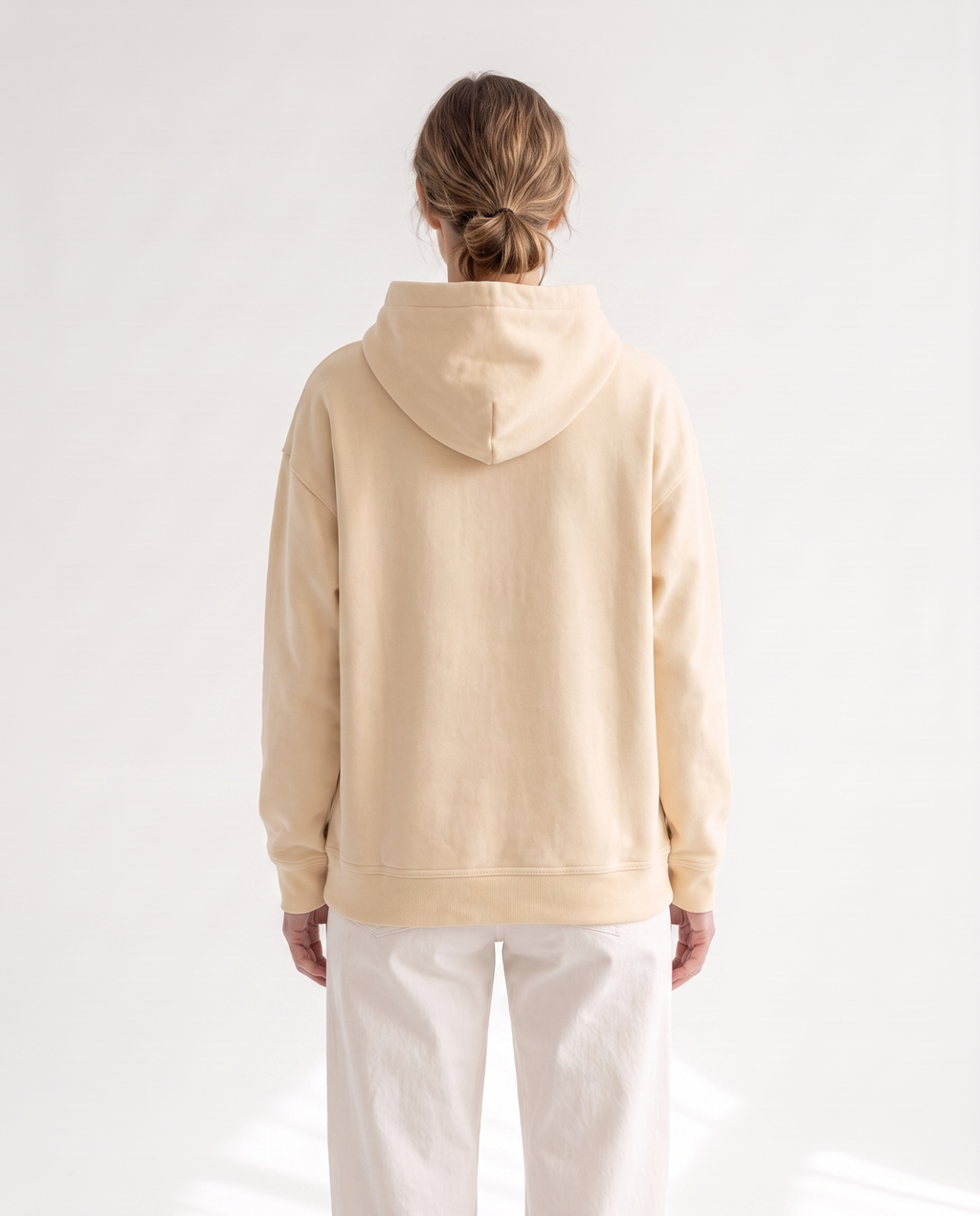 The Heavy Hoodie in apricot, back view showing the hood