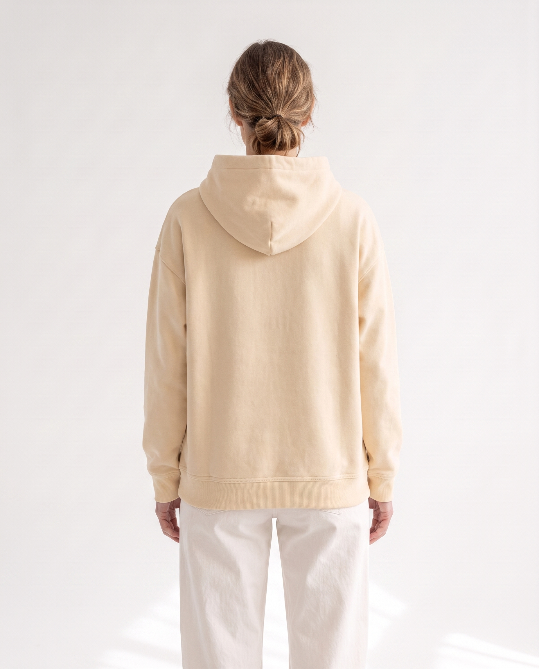 The Heavy Hoodie in apricot, back view showing the hood