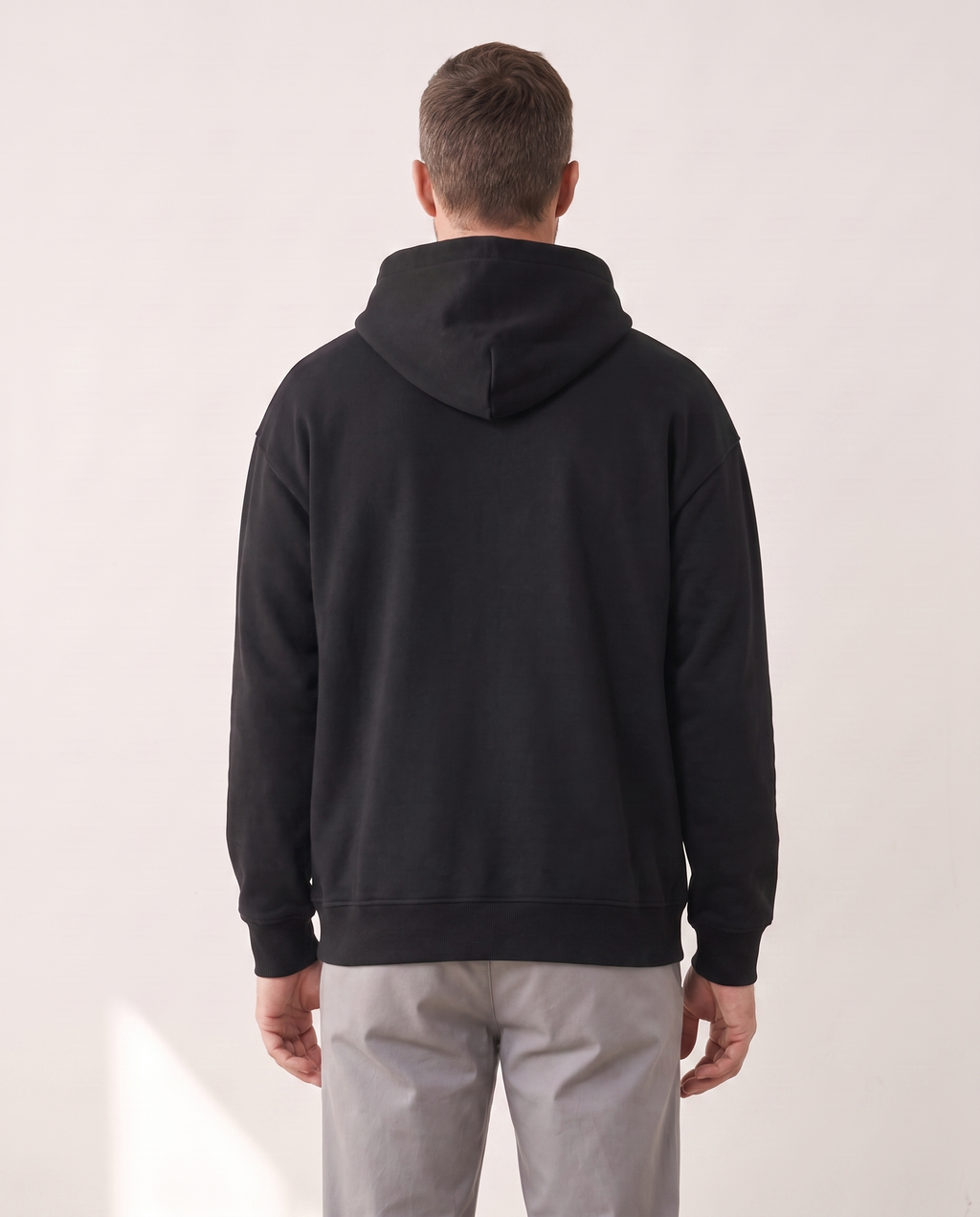 The Heavy Hoodie in black, back view showing the hood