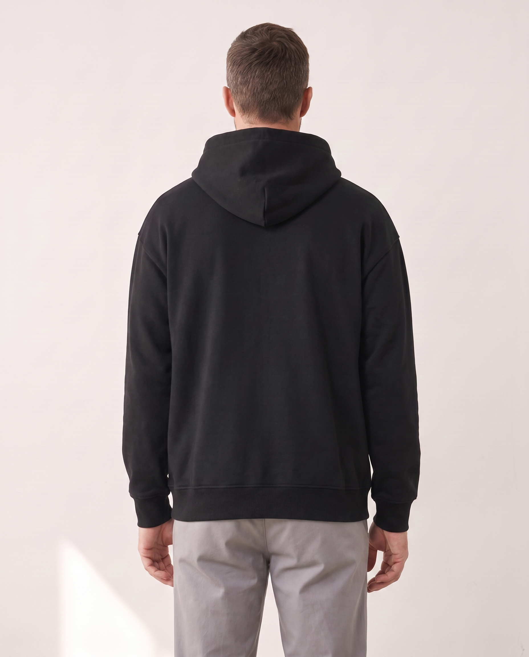 The Heavy Hoodie in black, back view showing the hood