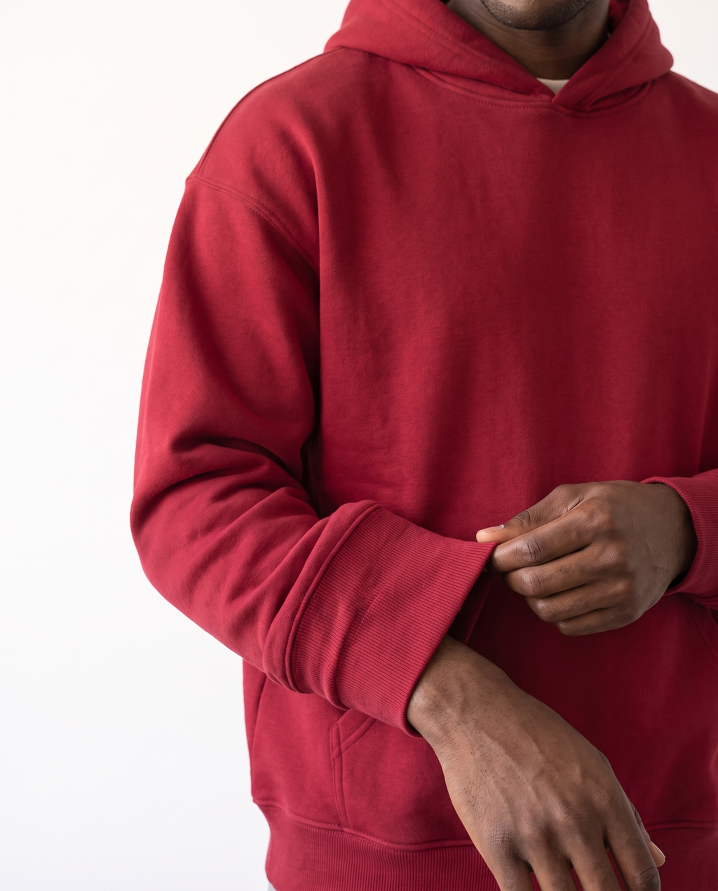 The Heavy Hoodie in red, ribbed cuff and fleece texture detail