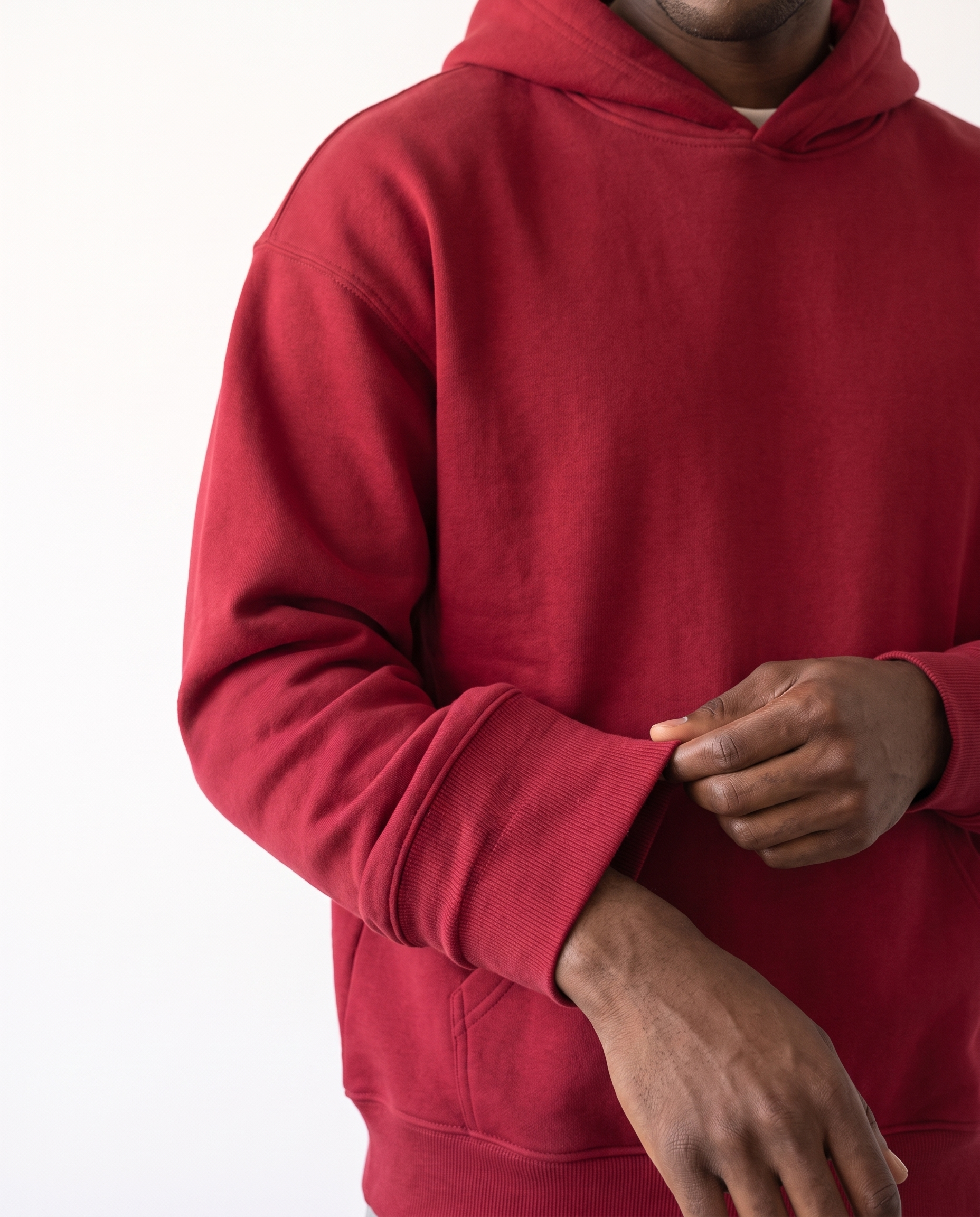 The Heavy Hoodie in red, ribbed cuff and fleece texture detail