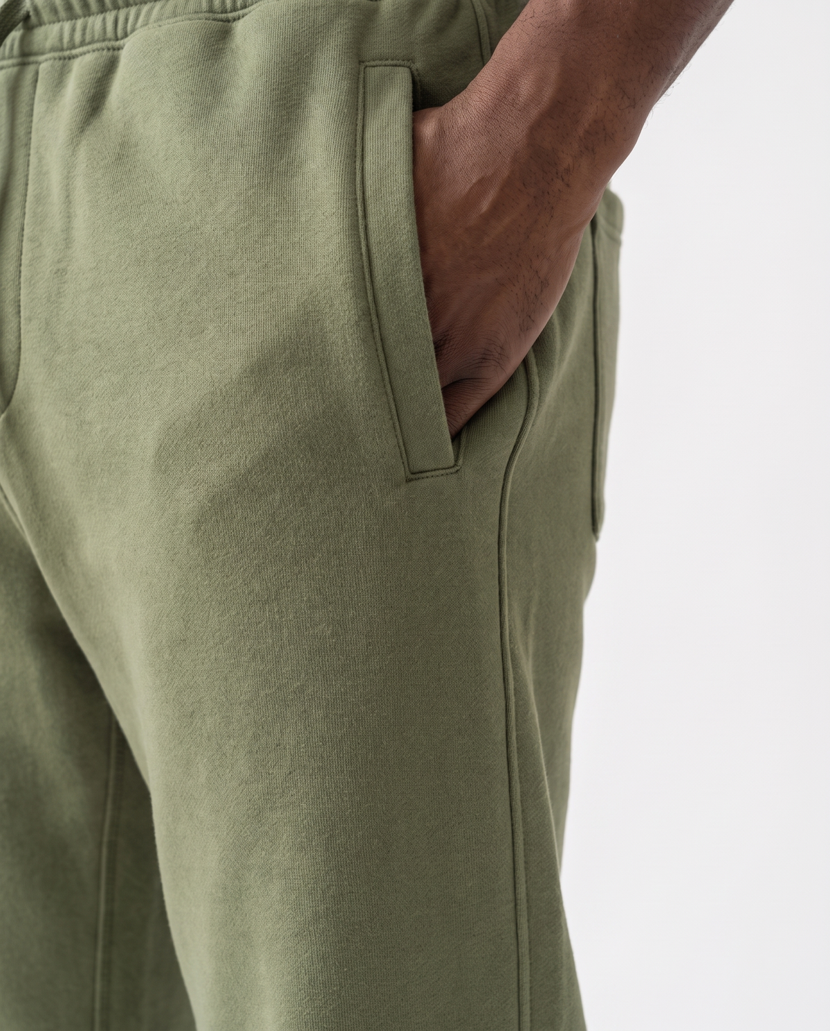 The Heavy Sweatpant in olive, side pocket and leg seams detail