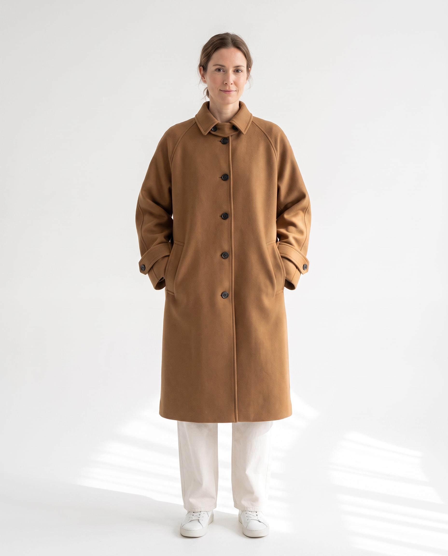 The Coat in camel, buttoned, full silhouette